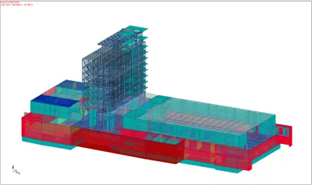 Modèle aux éléments finis de l'ensemble du projet — tour existante (en bleu) et infrastructure neuve (rouge/cyan) en phase de calcul.